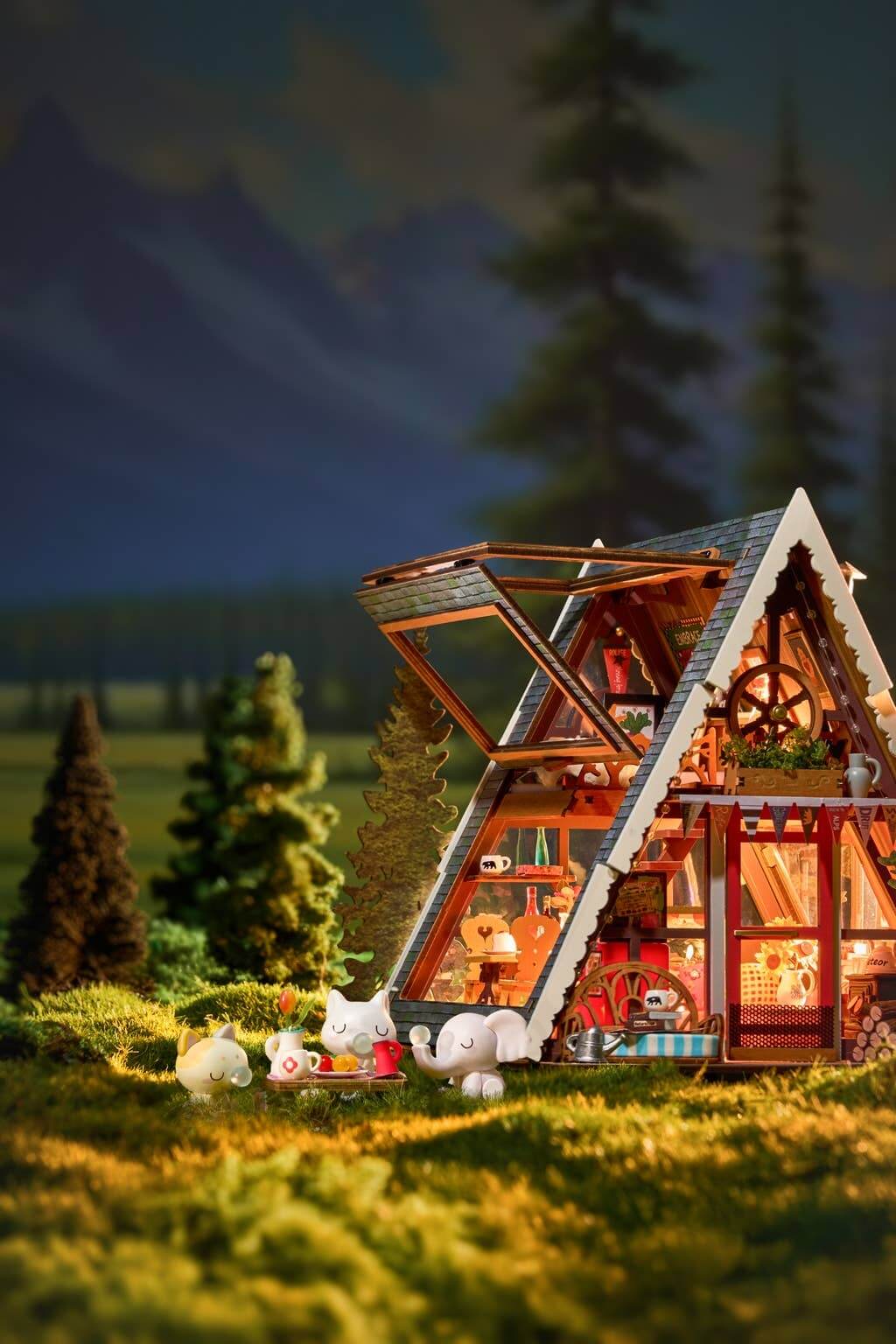 Miniature model of a A-Frame cabin in a forest with glowing interior lights