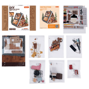 DIY miniature A-Frame Cabin kit components including packaging, instructions, and parts.