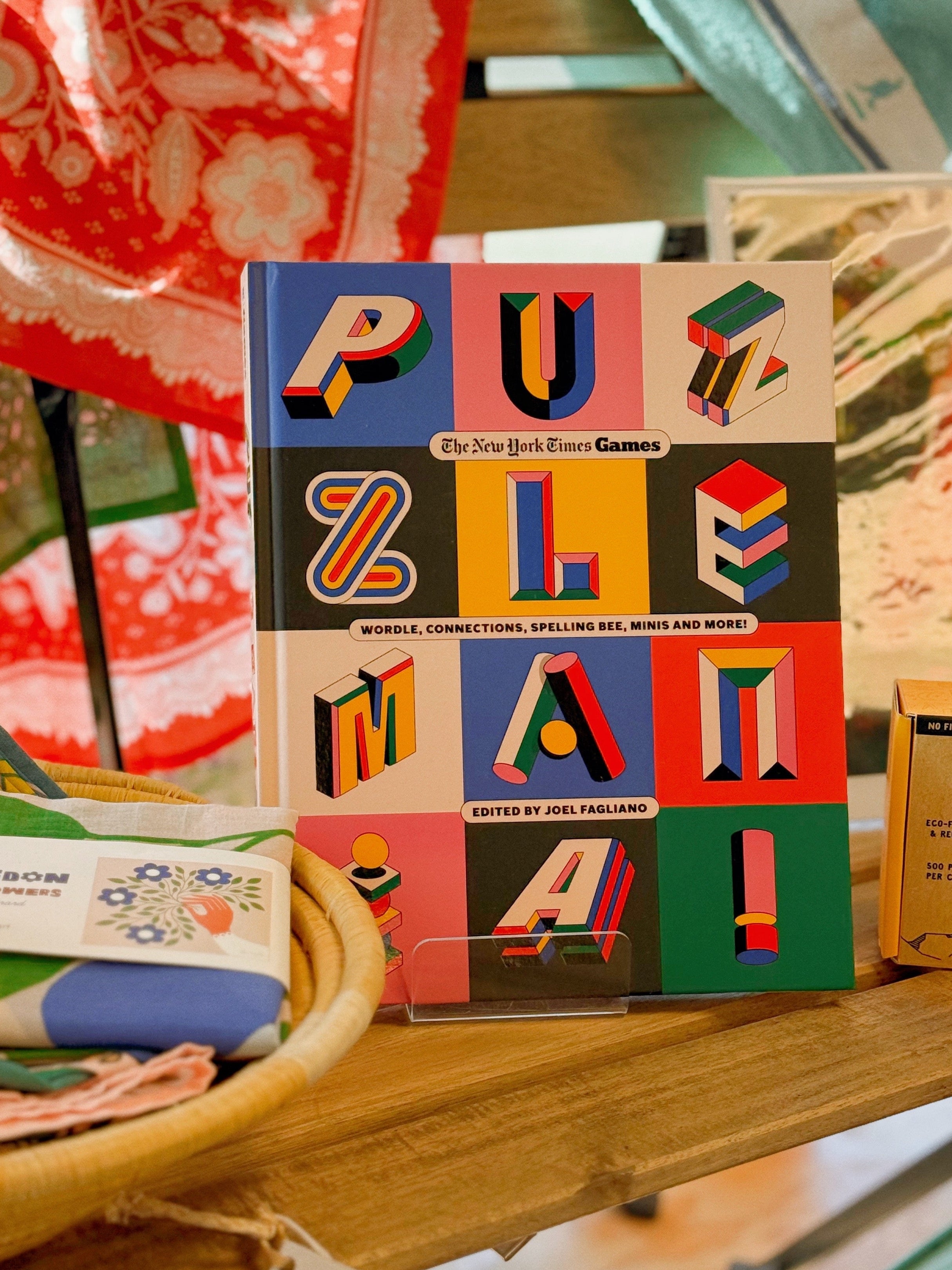 Colorful puzzle box on a wooden surface with a colorful blanket in the background