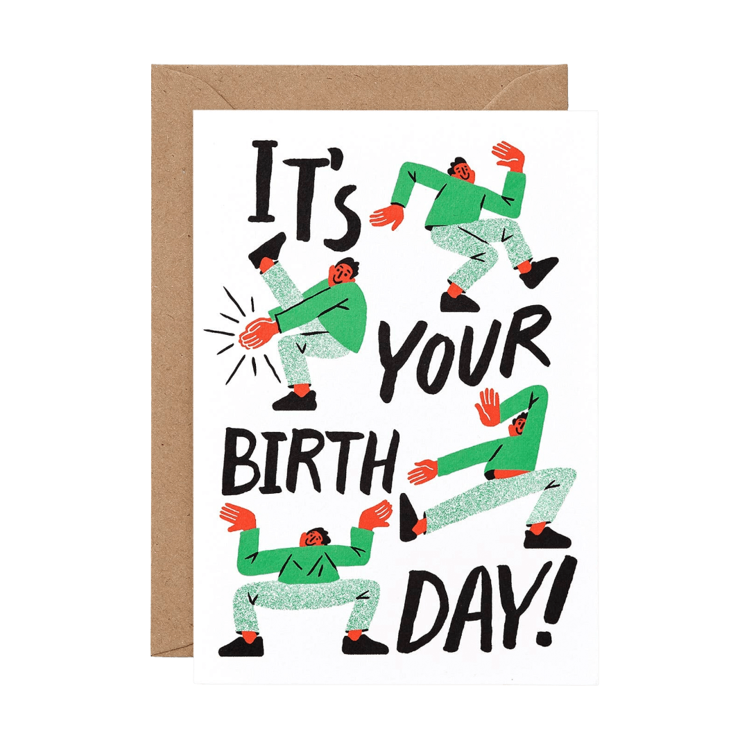 Birthday card with dancing figures and text 'It's Your Birthday!' on a white background.