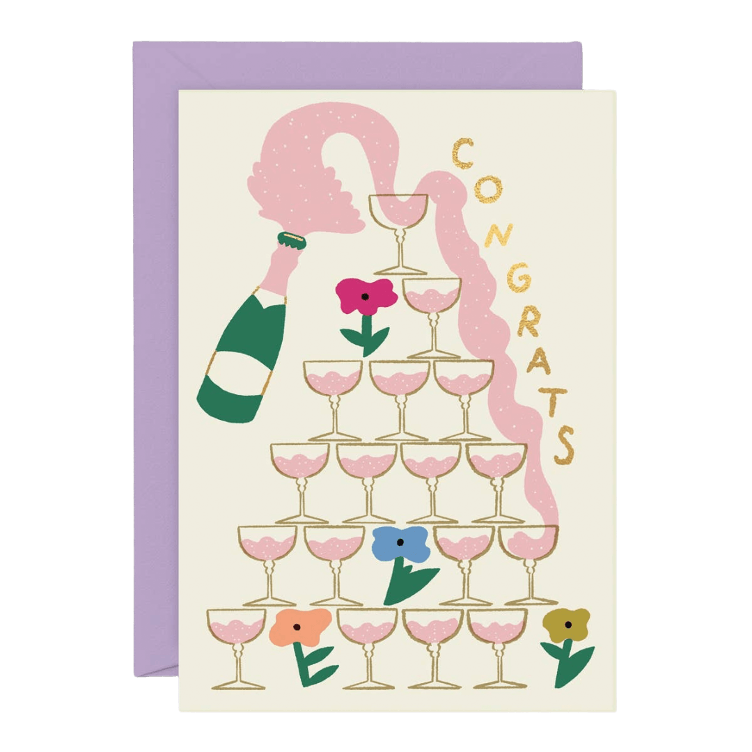 Greeting card with champagne bottle, glasses, and flowers on a beige background with a lavender envelope.