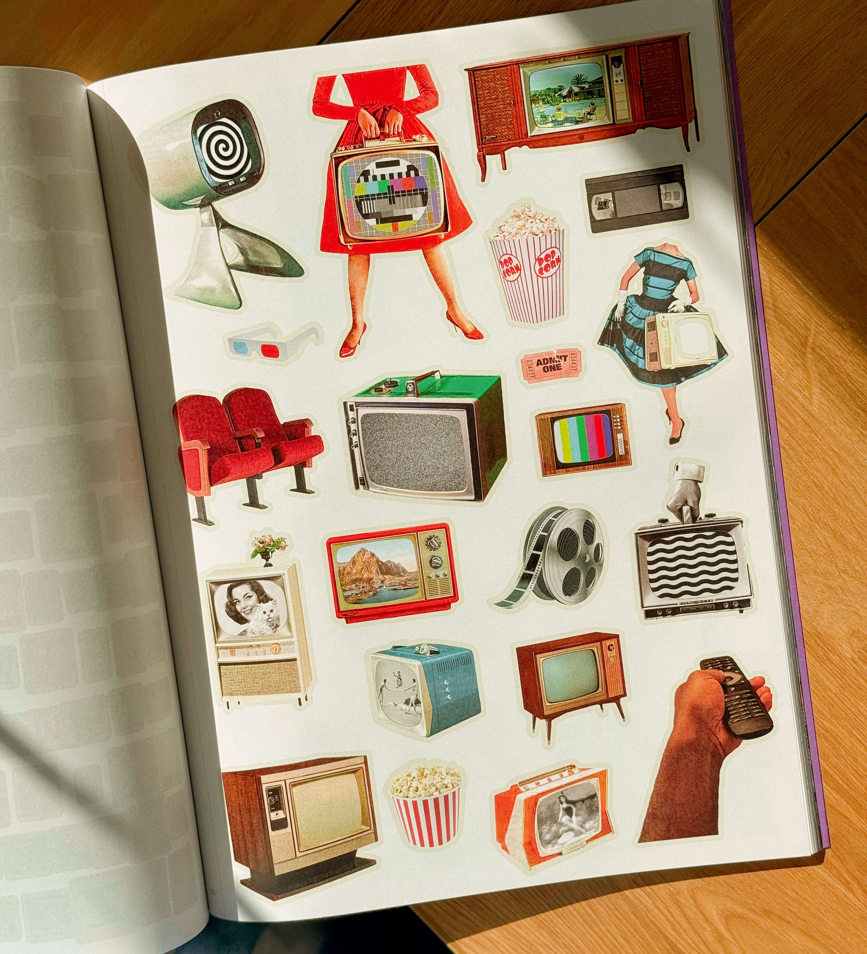 Open book with Illustrated images with retro-themed objects on a wooden surface