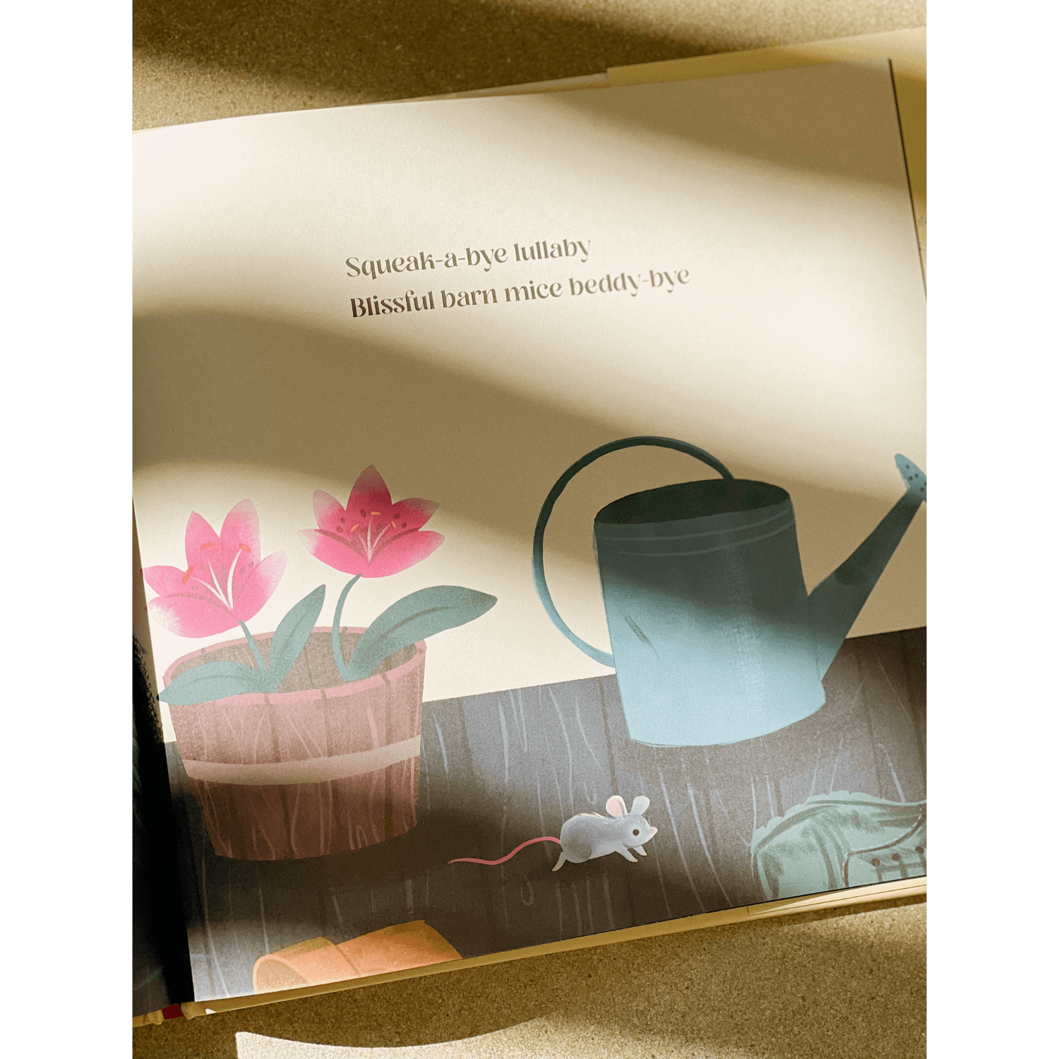 Illustration of a watering can, flowers, and a mouse in a children's book.