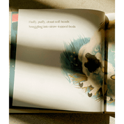 Open book with a page showing an illustration of a sheep and text.