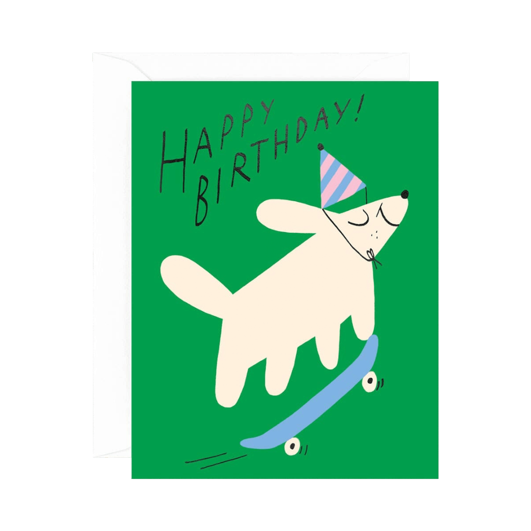 Birthday card with a dog on a skateboard and 'Happy Birthday!' text on a green background