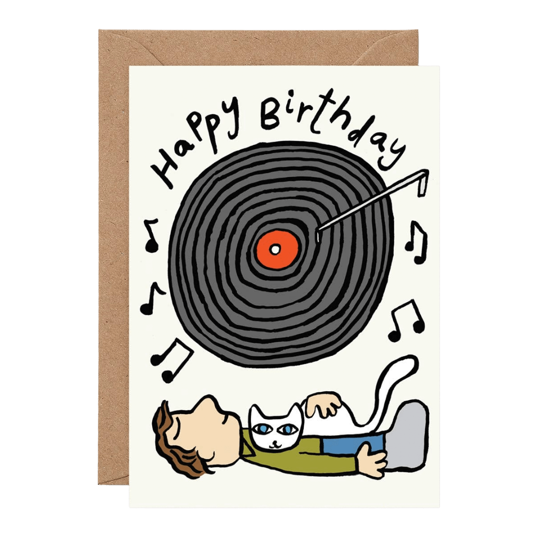 Birthday card with a vinyl record and person with a cat listening to music, on a white background.