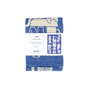 Folded blue tea towel with white patterns and a label