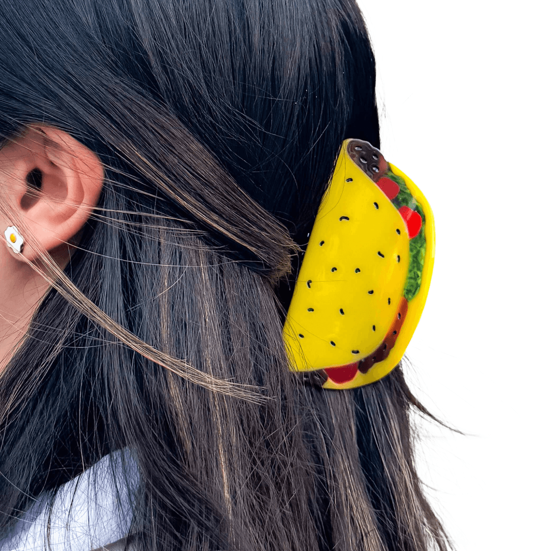 Person wearing a hair claw clip shaped like a taco with visible fillings.