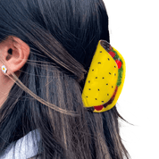 Person wearing a hair claw clip shaped like a taco with visible fillings.