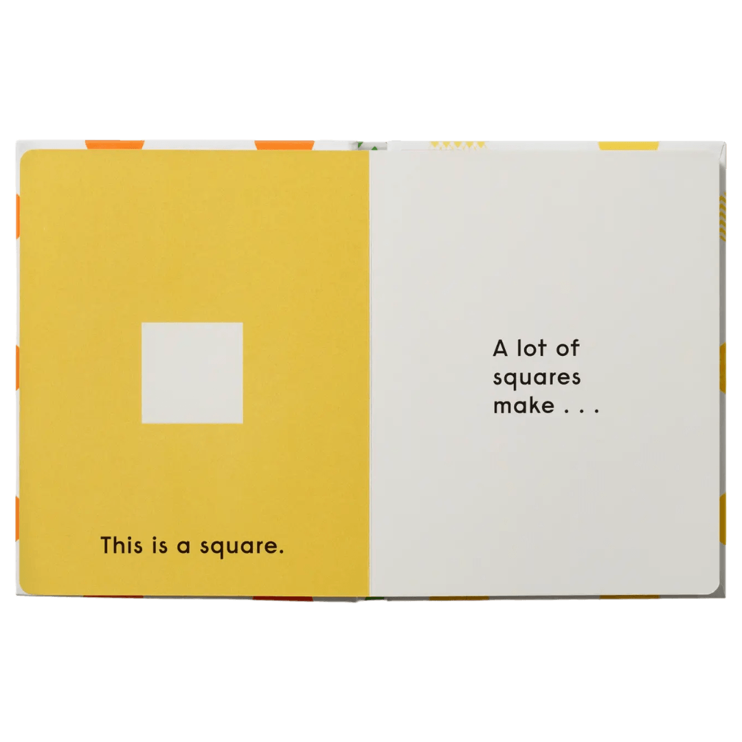 Open book with yellow and white pages showing geometric shapes and text.