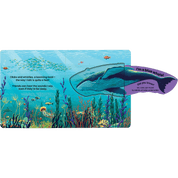 Children's book open with pages of a whale illustration on an underwater scene.