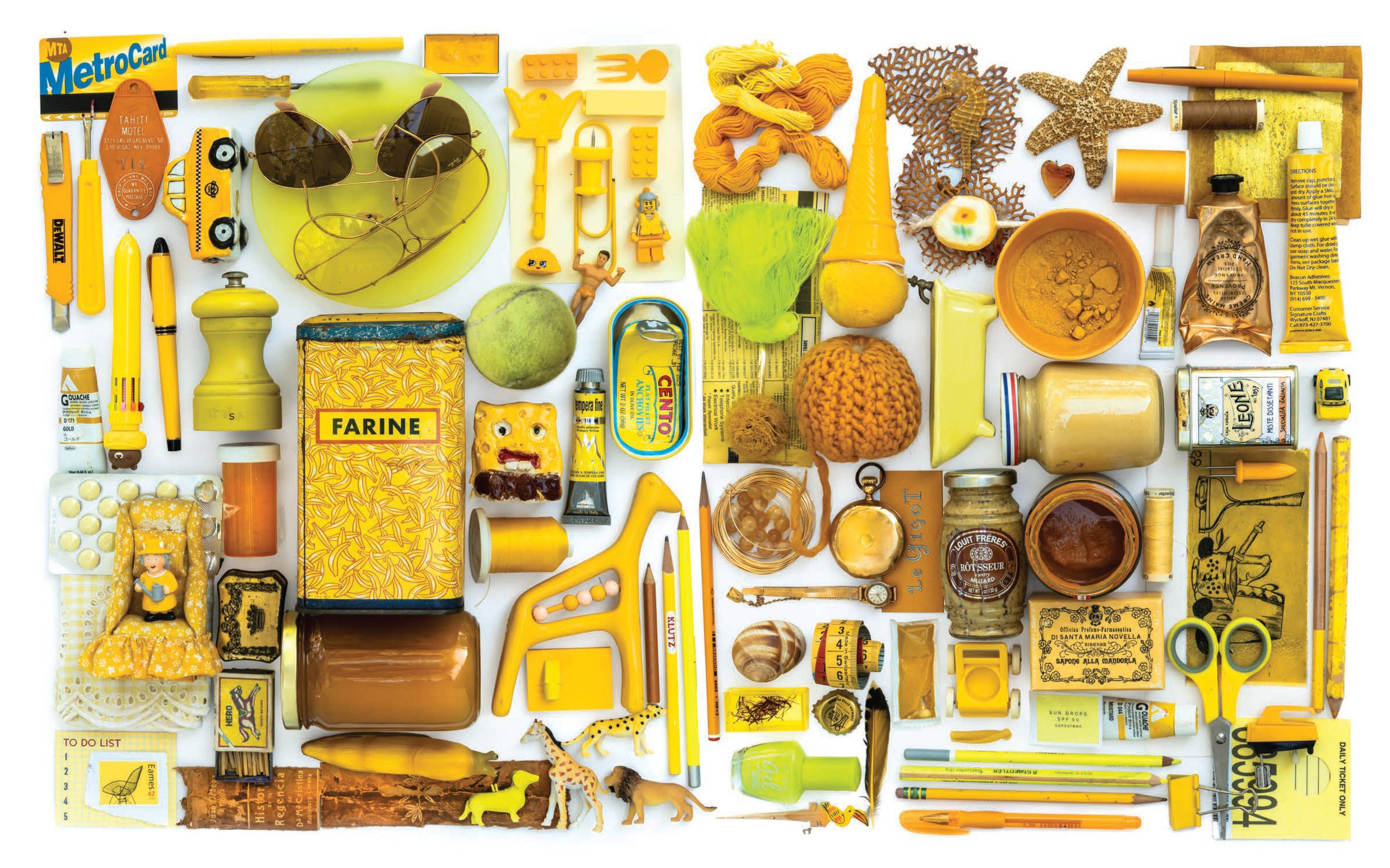 Collection of various yellow items and products on a white background