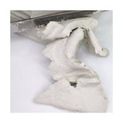 White clay being sliced on a white surface