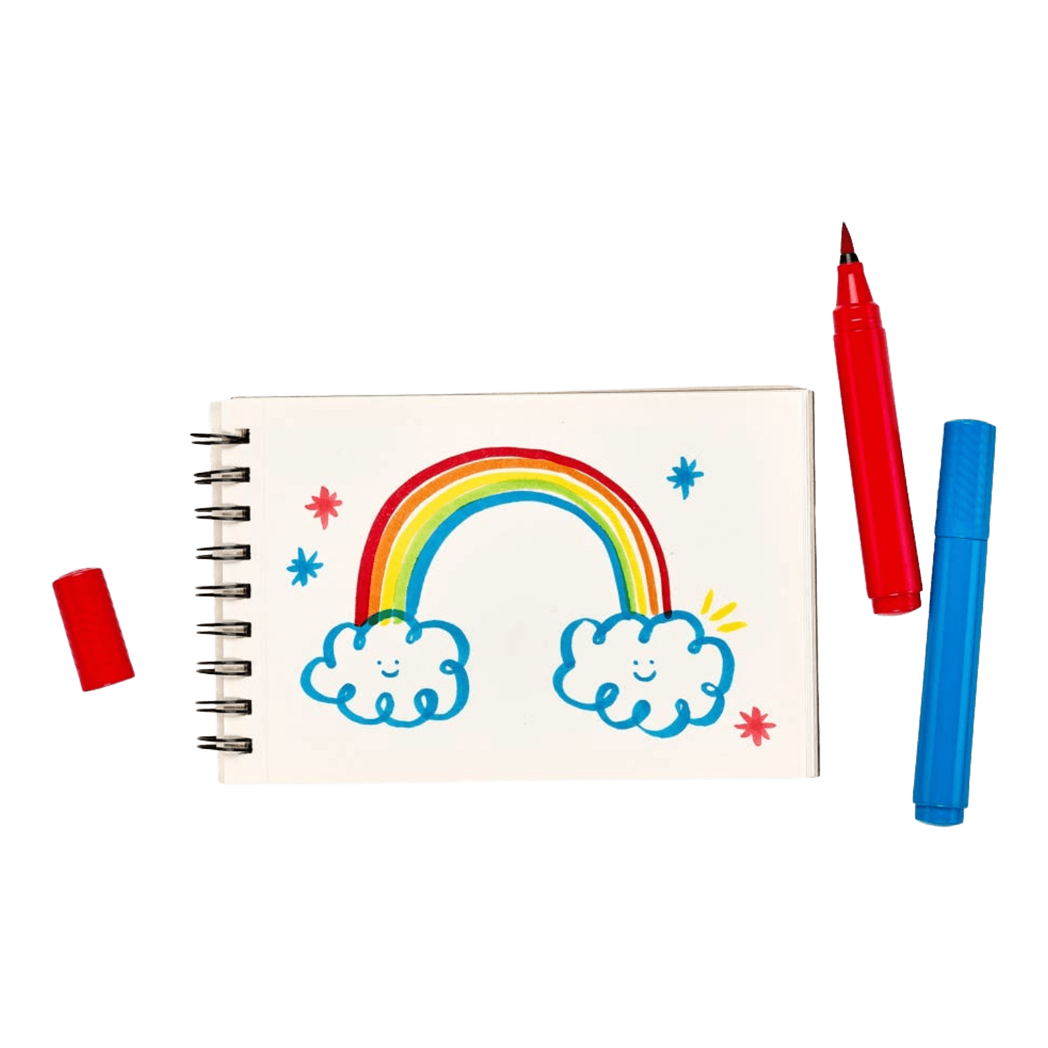 Notebook with a rainbow and cloud drawing, surrounded by markers.
