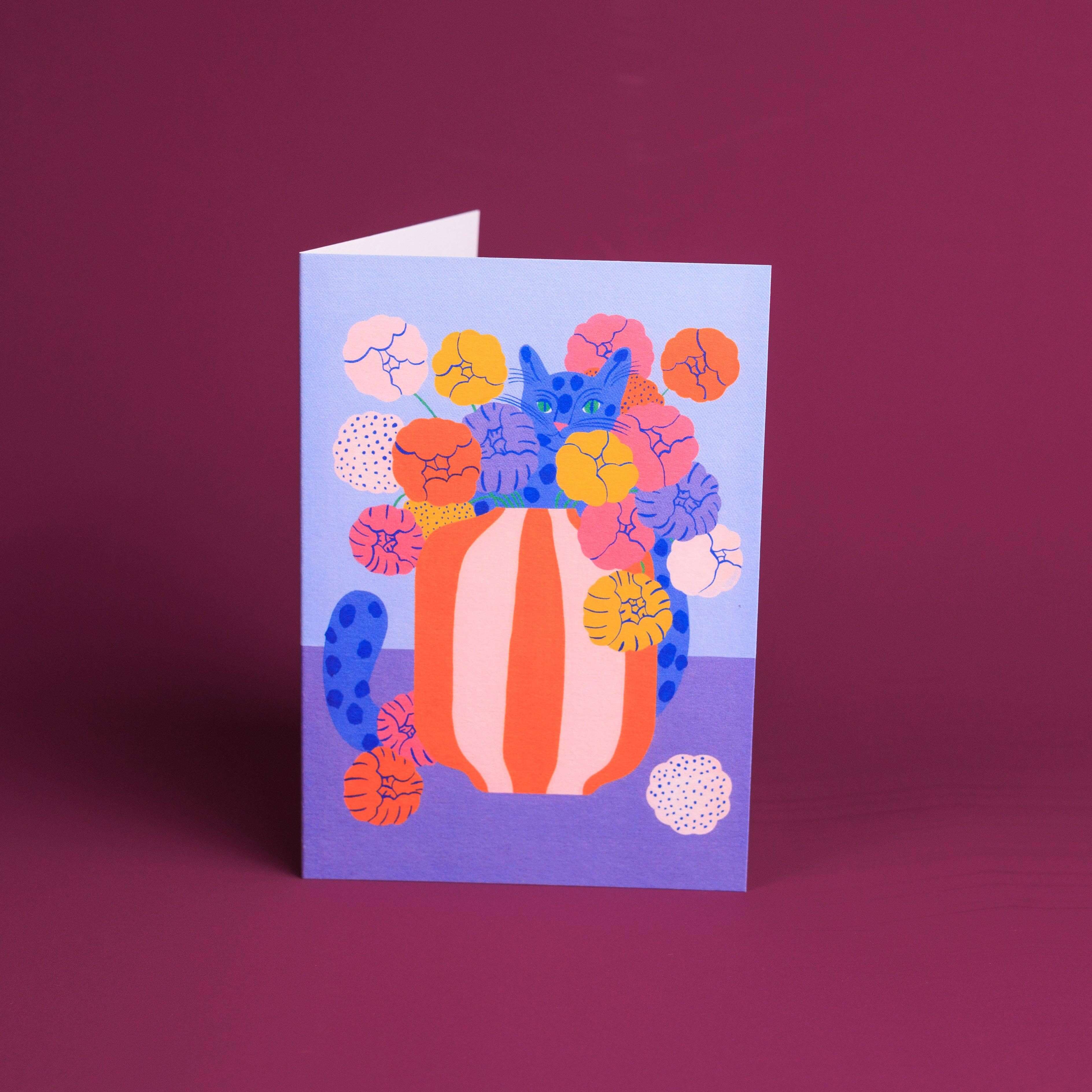 Greeting card with colorful floral design on a purple background
