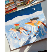 Painting of two cowgirls on horseback with a watercolor palette lying on a desk and brushes in the background.