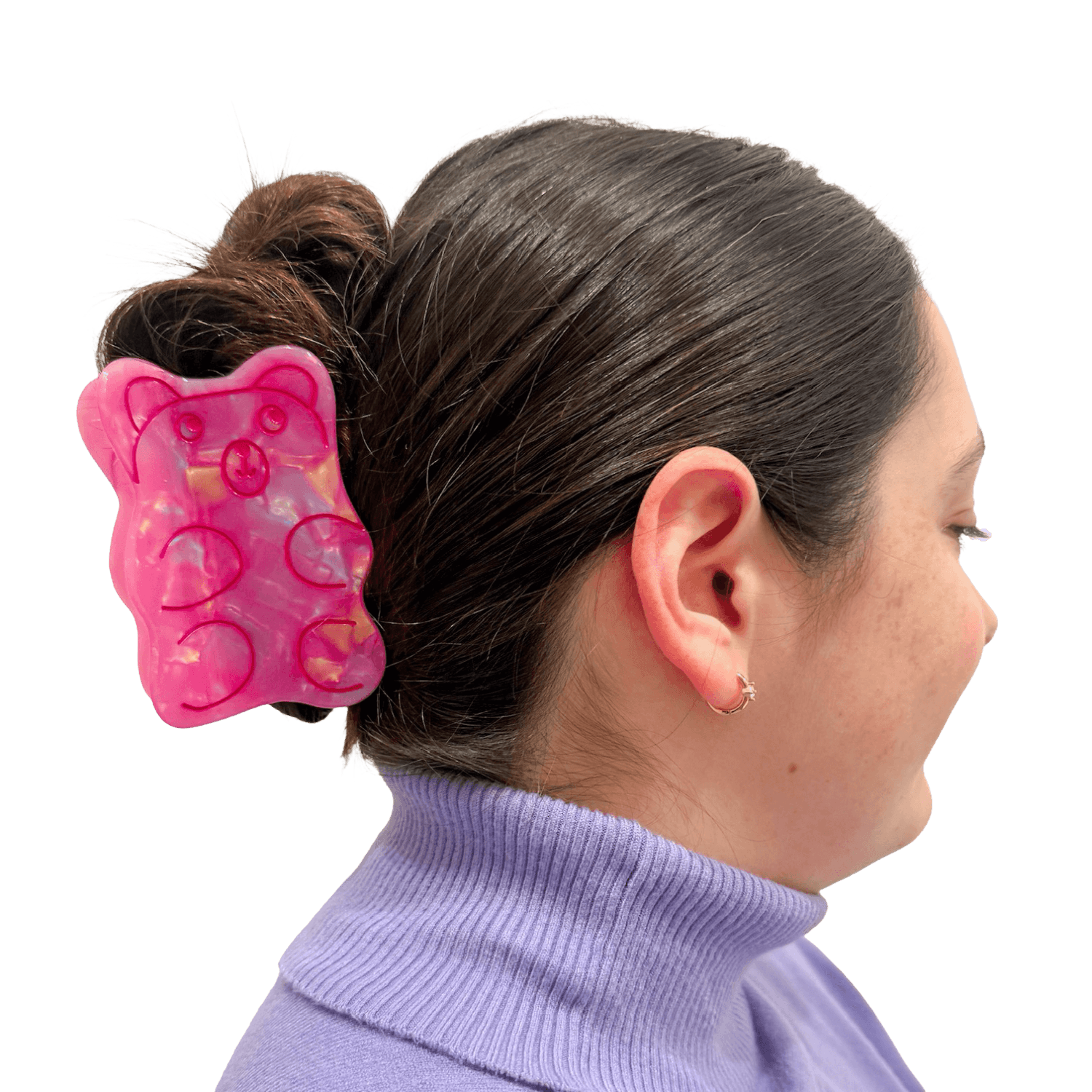 Large pink gummy bear shaped hair clip in a person's hair