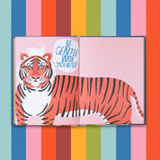 Illustration of a tiger with a motivational quote on a colorful striped background