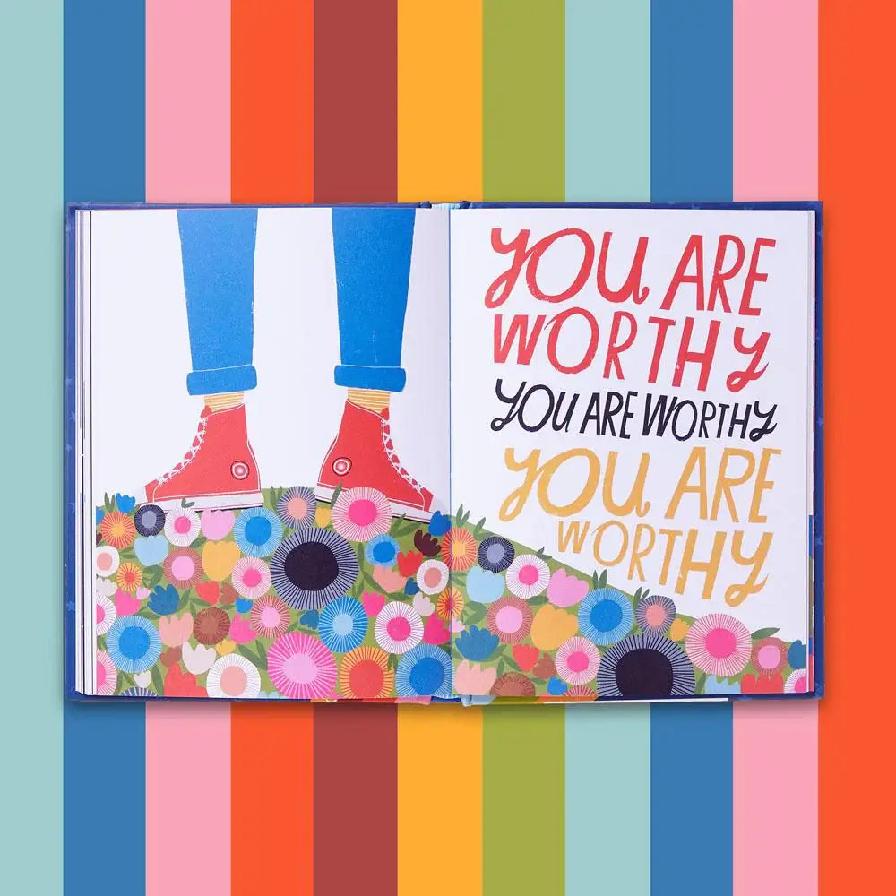 Open book with motivational text 'YOU ARE WORTHY' on a colorful striped background