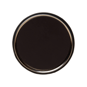 Round black object with a metallic rim on a black background
