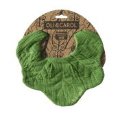Green bib with leaf pattern on a brown package labeled 'Oli & Carol'.