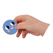 Hand holding a blue circular magnet with a face design