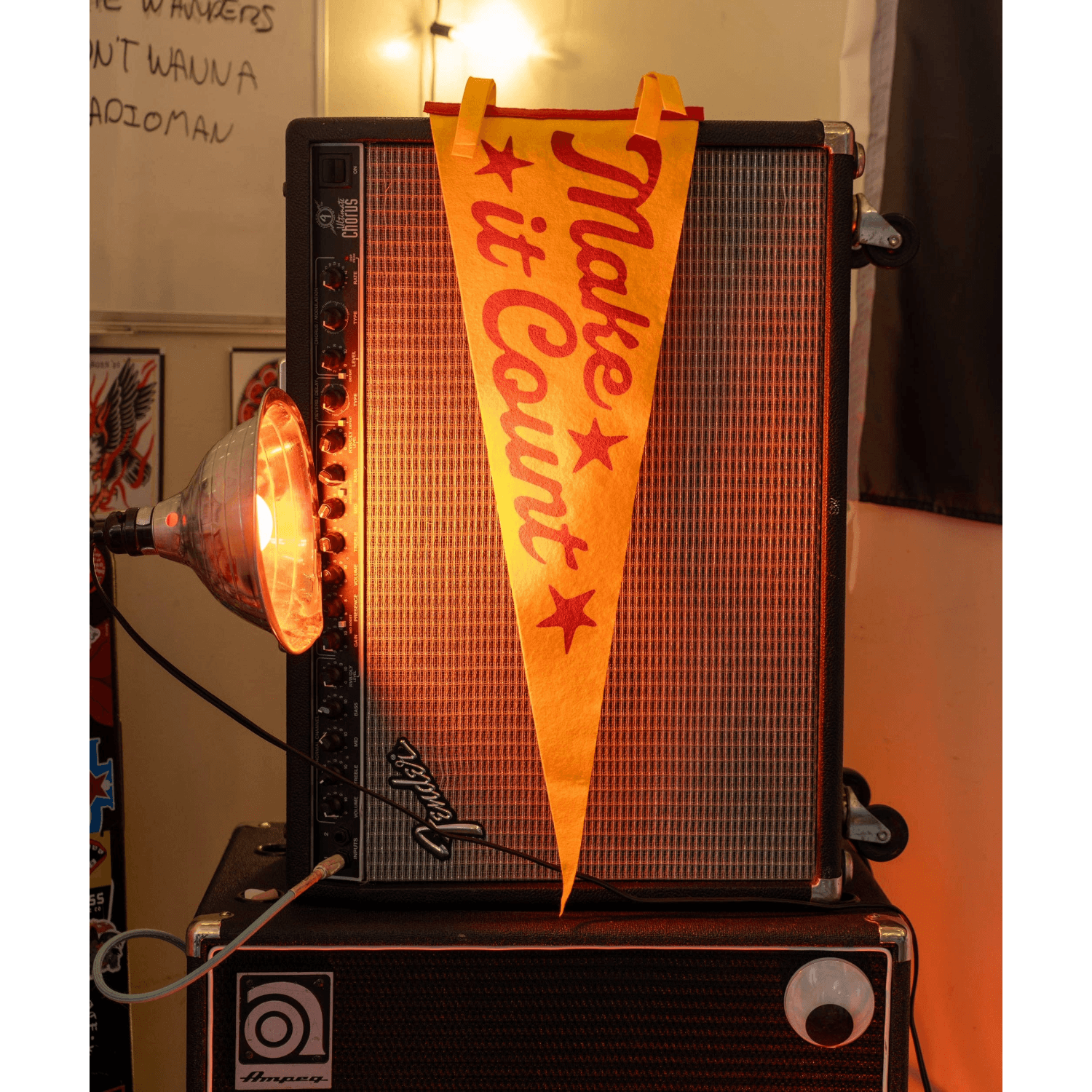 Amplifier with a 'Make it Count' flag on top, surrounded by various items in a room.