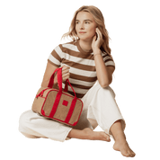 Woman holding a brown and red bag
