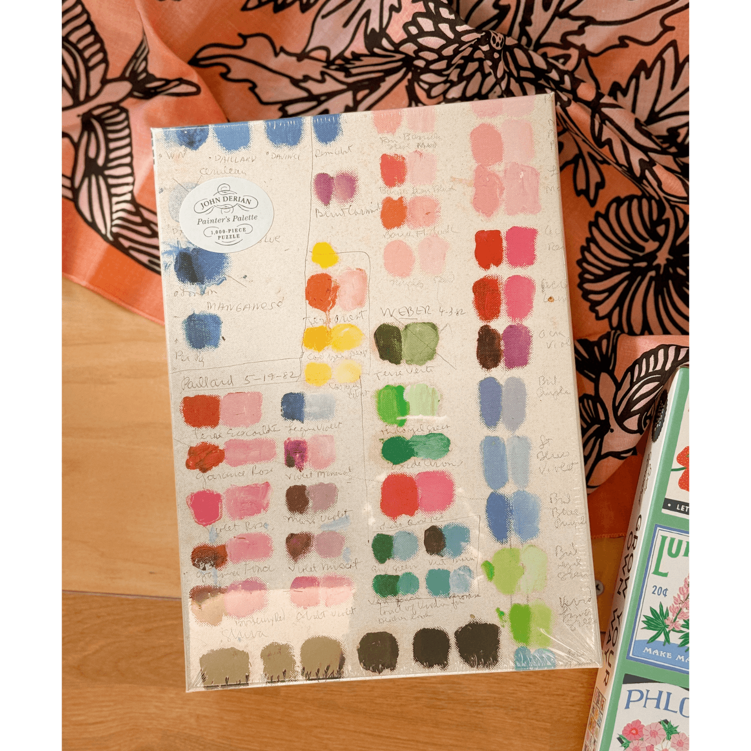 Color swatch chart with paint samples puzzle on a wooden surface