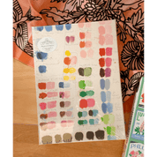 Color swatch chart with paint samples puzzle on a wooden surface
