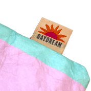 Fabric with a 'Daydream' label featuring a sun design.