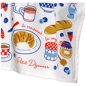 White towel with colorful illustrations of french breakfast items including a croissant, coffee, and jam.