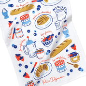 Colorful towel with French breakfast-themed illustrations on a white background