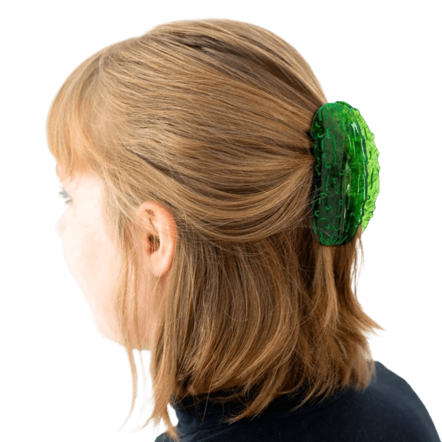 Person with green pickle hair clip in light brown hair