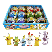 A box of Pokémon surprise egg mystery toys with several colorful eggs visible inside, plus five small character figurines displayed in front on a white background.