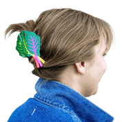 Person wearing a colorful hair clip with leaf design