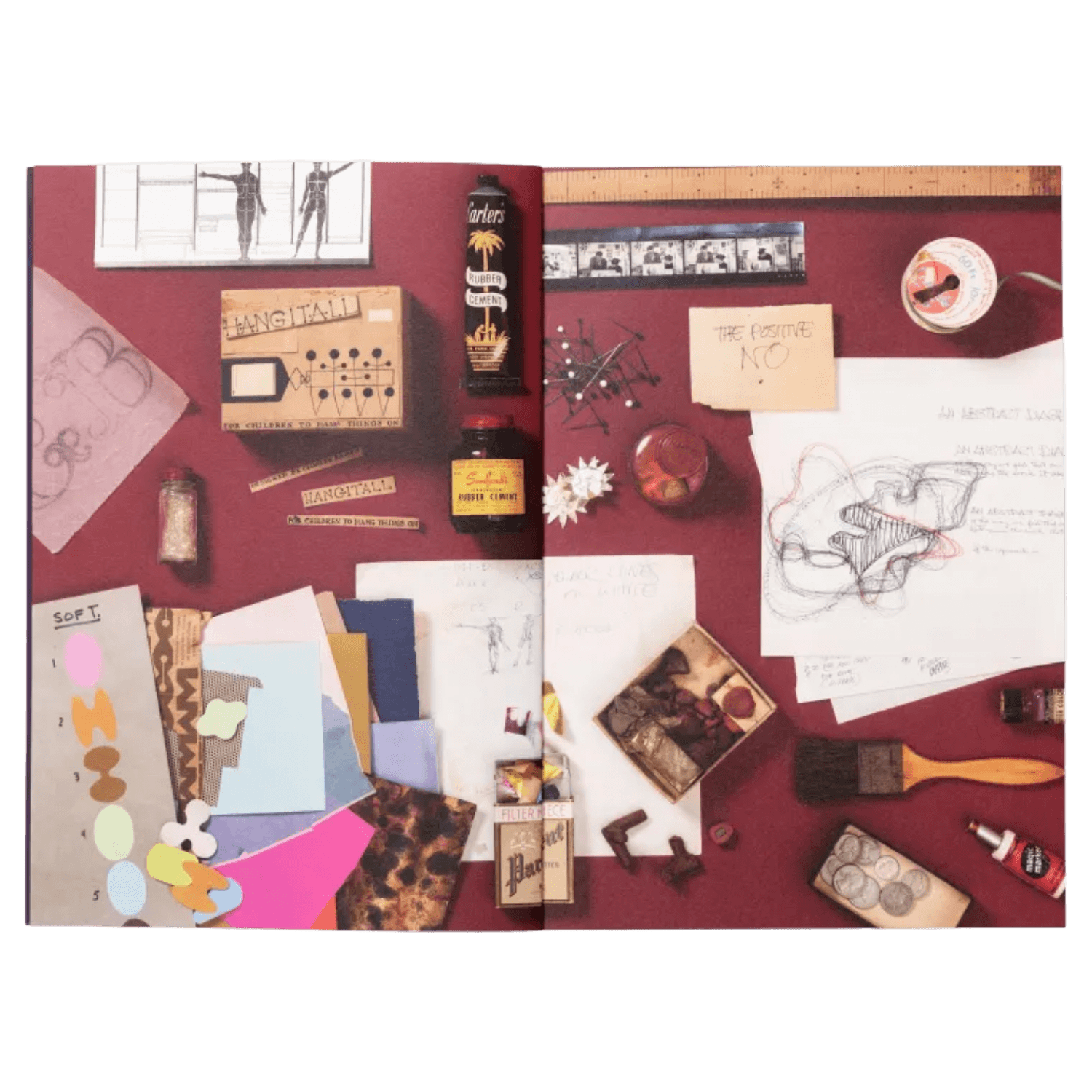 Book pages of collage of art supplies and materials on a red background
