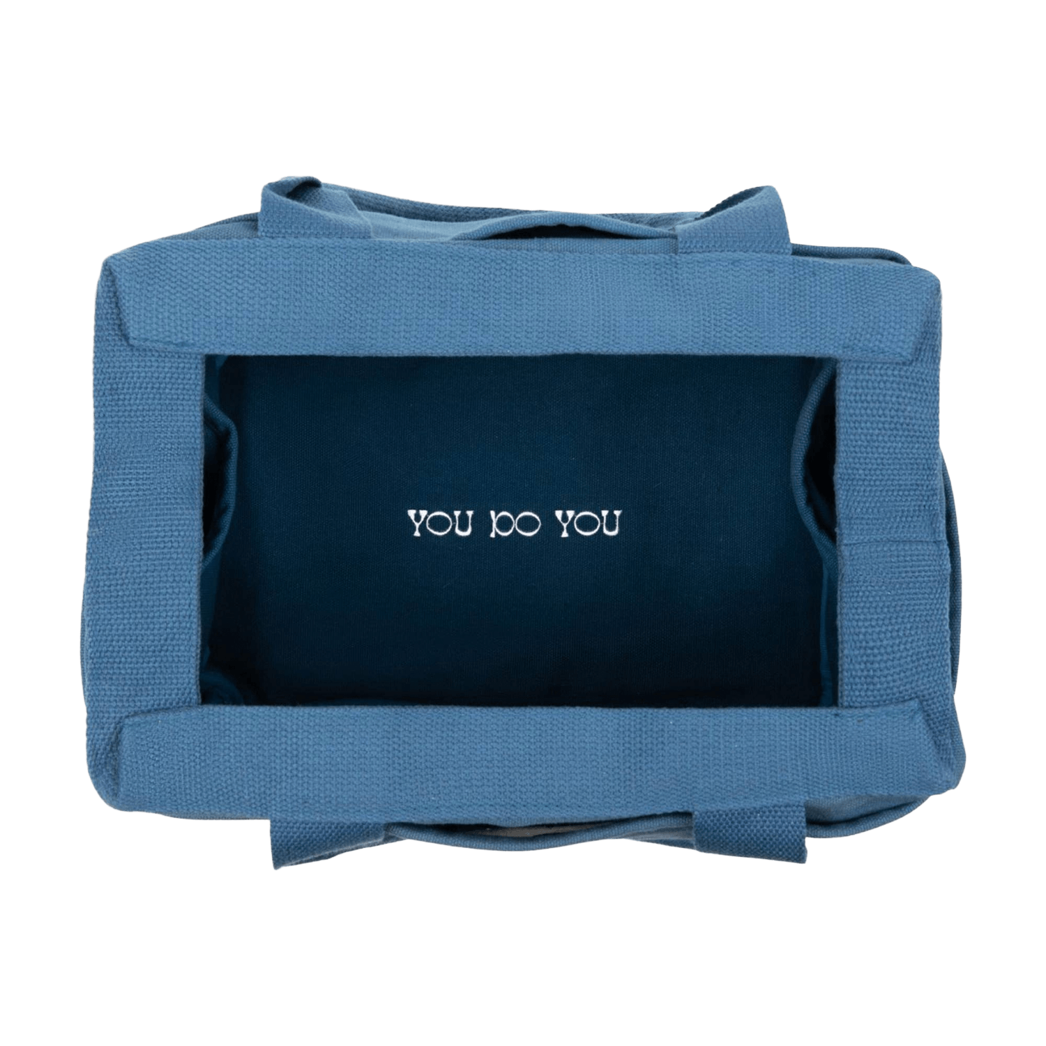 Inside of a blue painter's bag with 'YOU DO YOU' text on the bottom of the bag.