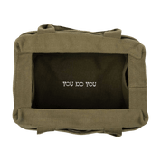 Inside of a green bag with 'YOU DO YOU' text on the inside bottom.
