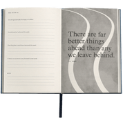 Open notebook with a quote by C.S. Lewis on a gray background