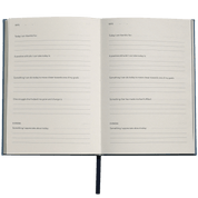 Open notebook with daily reflection prompts.