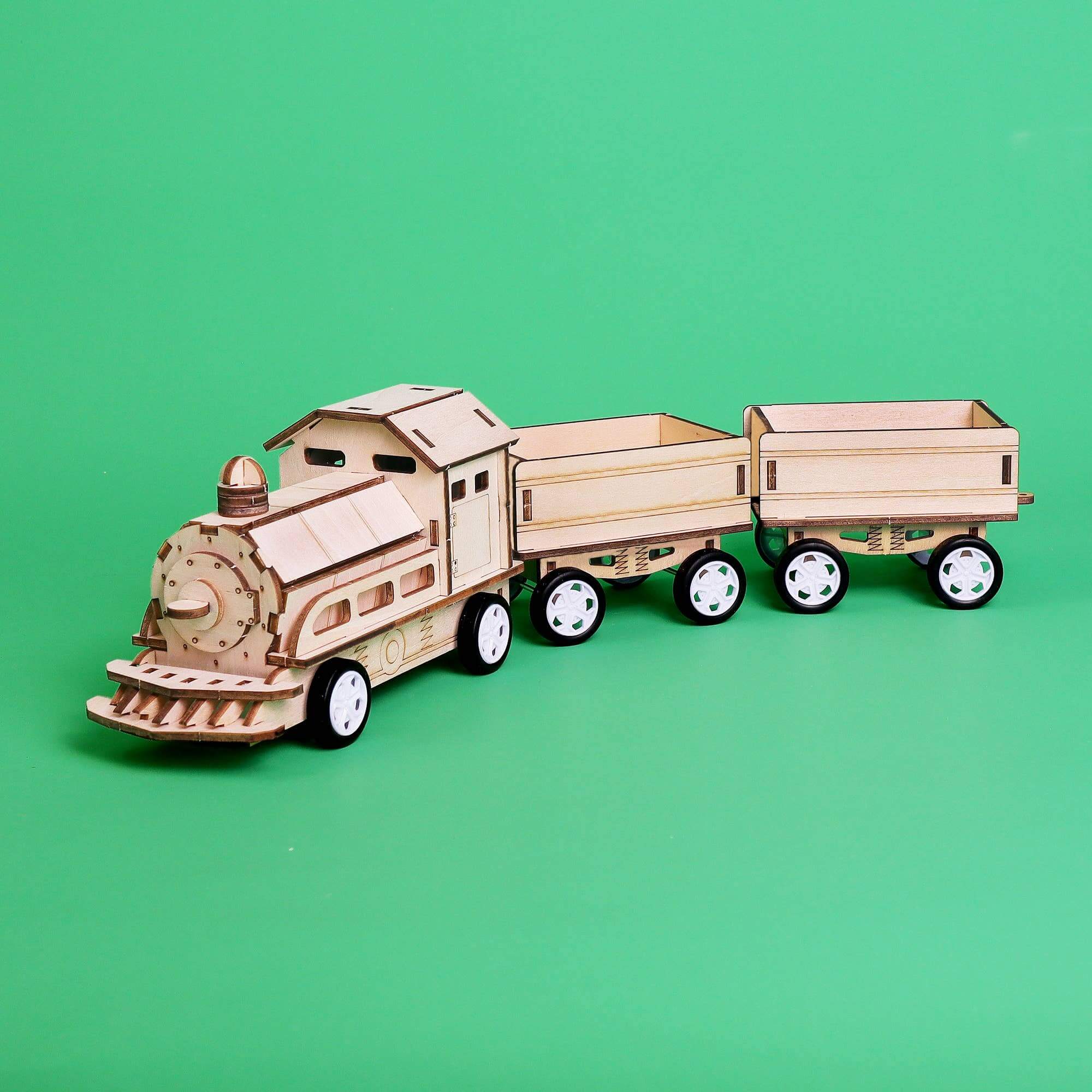 Wooden toy train set on a green background