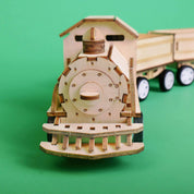 Wooden toy train model on a green background