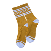 Mustard yellow socks with white stripes and text.